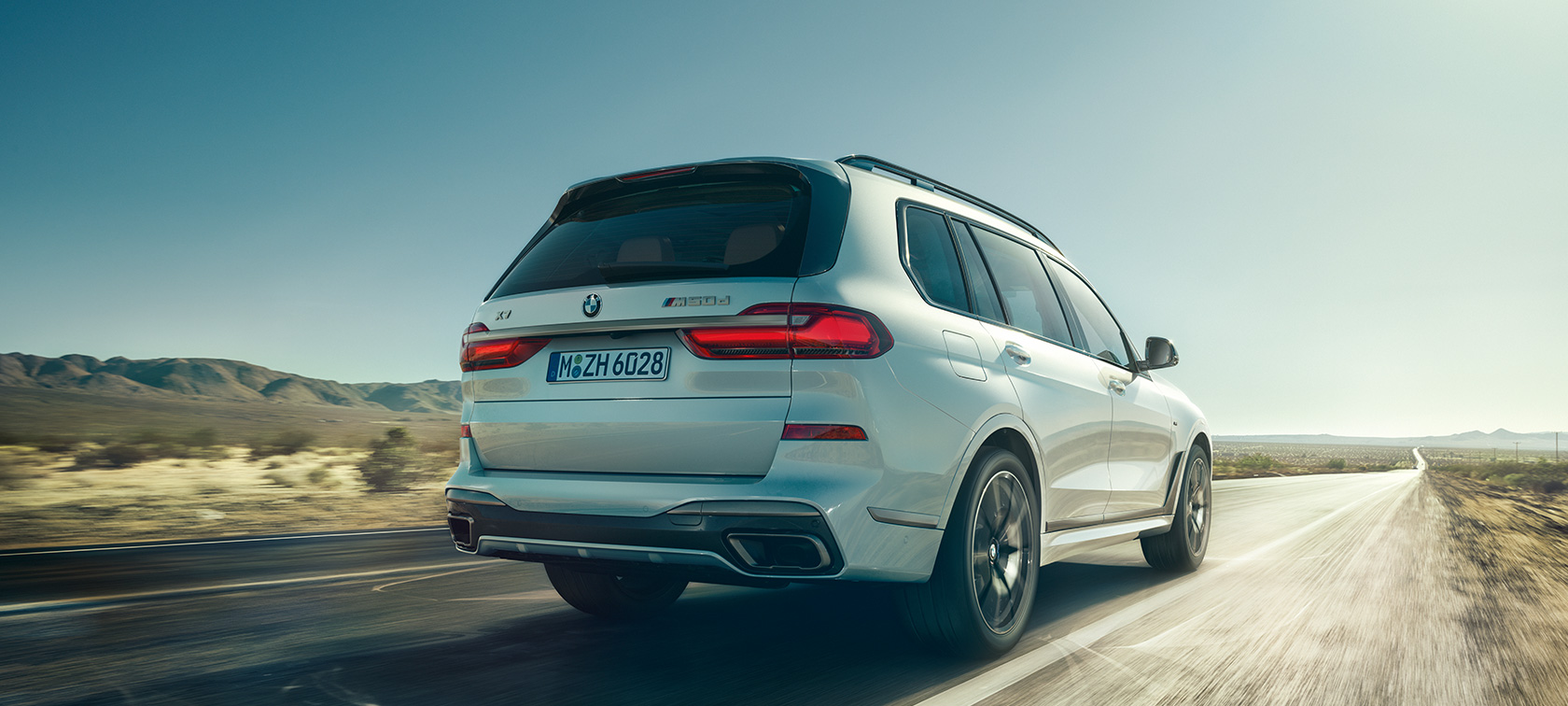 BMW X7 M50d, rear view BMW X7 M50d in Mineral White, driving on an empty highway, rear view, G07, 2019